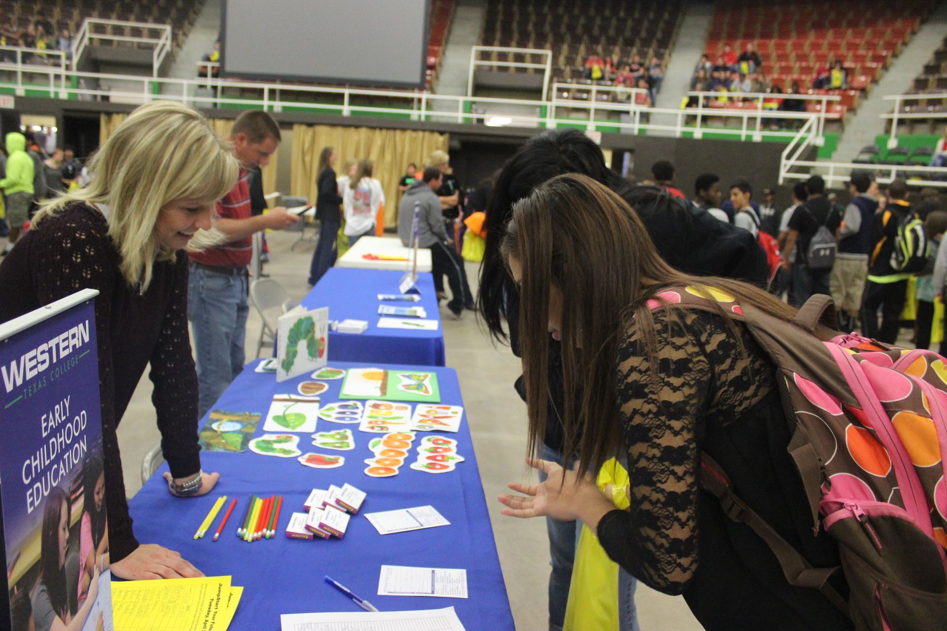 Students look at materials from early childhood program.